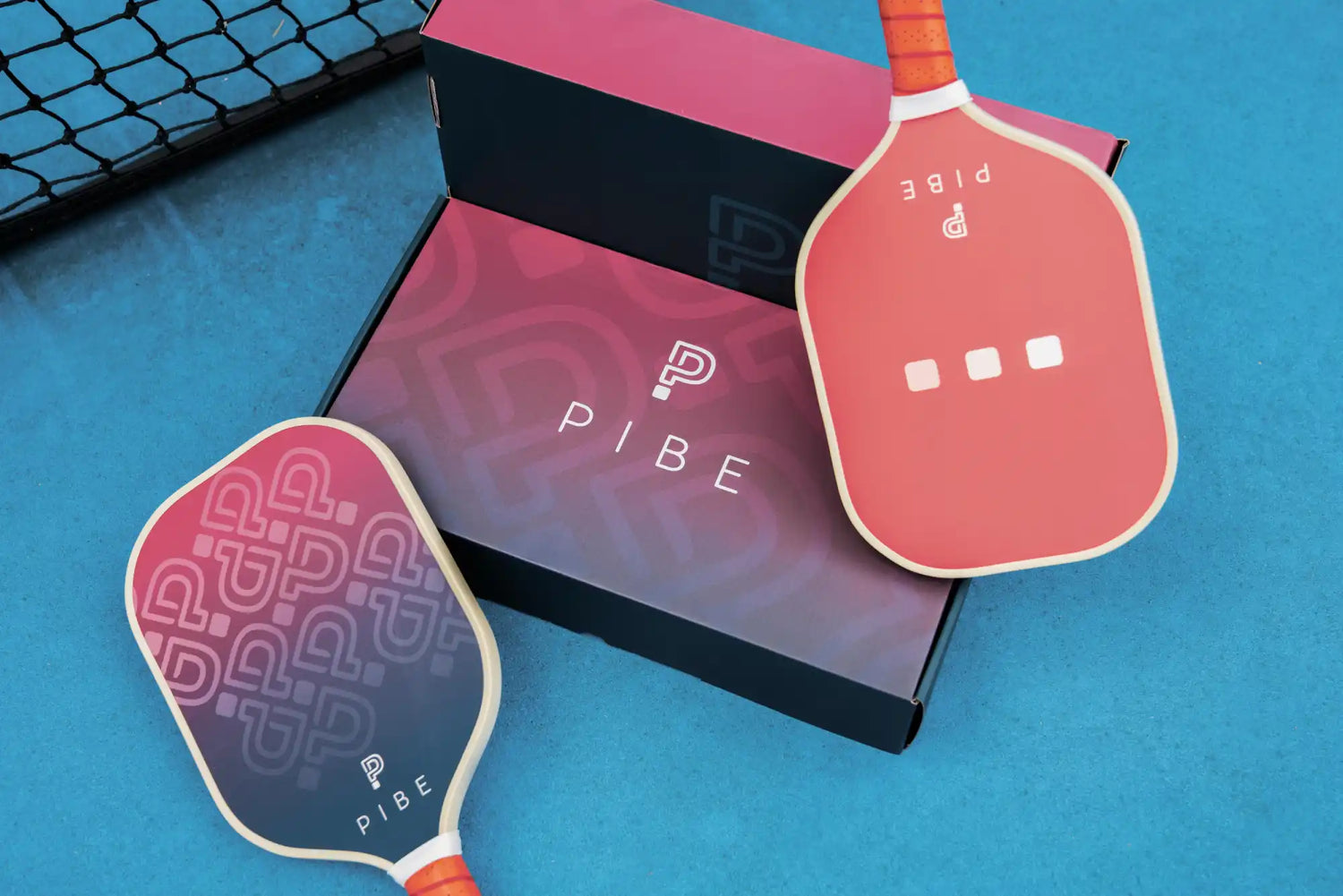 Pink stickers or decals featuring balloon-like shapes alongside a dark box with ’PIRE’ text.